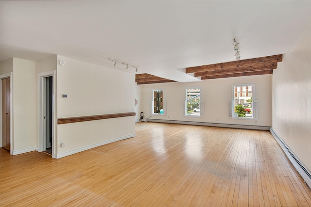 89 College St Unit A-2, Burlington, VT 05401 - empty room with rail lighting, baseboard heating, light wood finished floors, and beamed ceiling