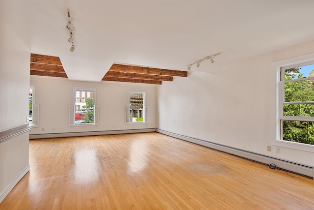 89 College St Unit A-2, Burlington, VT 05401 - unfurnished living room with track lighting, light wood finished floors, and baseboard heating