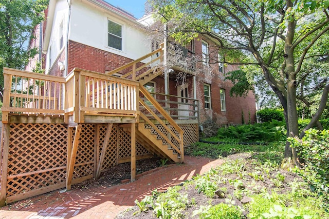 89 College St Unit A-2, Burlington, VT 05401 - back of house with brick siding, a deck, stucco siding, and stairway