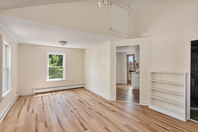 89 College St Unit A-2, Burlington, VT 05401 - empty room with a baseboard radiator, light wood-style floors, and high vaulted ceiling