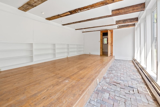 526 River Rd, Lyme, NH 03768 - spare room featuring beamed ceiling, a baseboard heating unit, and brick flooring