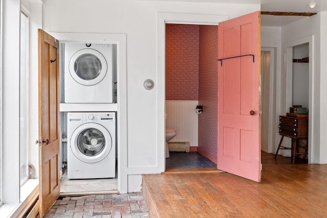 526 River Rd, Lyme, NH 03768 - laundry room with stacked washing machine and dryer, wallpapered walls, and wainscoting