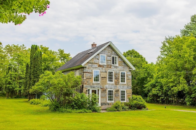 526 River Rd, Lyme, NH 03768 - view of property exterior featuring stone siding, a lawn, and a chimney