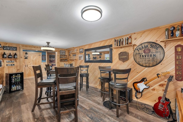 55 Trask Side Rd, Alton, NH 03810 - dining space with wooden walls and dark wood-style flooring