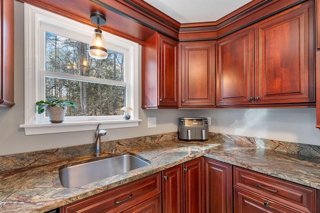 55 Trask Side Rd, Alton, NH 03810 - kitchen with reddish brown cabinets, hanging light fixtures, and stone countertops