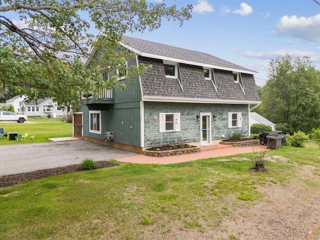 183 Summer St, Newport, NH 03773 - rear view of house featuring a shingled roof, a lawn, and a patio