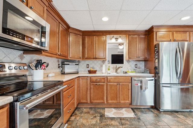 183 Summer St, Newport, NH 03773 - kitchen featuring stainless steel appliances, light countertops, brown cabinets, recessed lighting, and a drop ceiling
