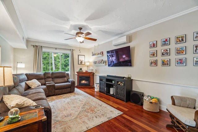 183 Summer St, Newport, NH 03773 - living area featuring a wall mounted air conditioner, crown molding, wood finished floors, a ceiling fan, and a lit fireplace