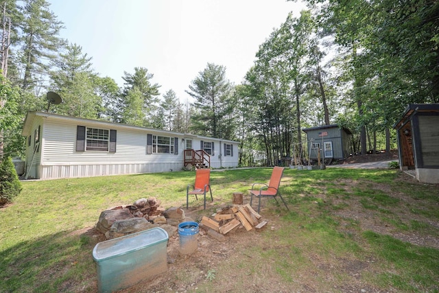 44 Hoit Mill Rd, Weare, NH 03281 - view of green lawn with a storage shed and an outdoor fire pit