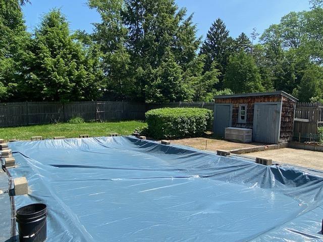 15 Vernon Ave, Rochester, NH 03867 - view of pool with a fenced backyard and a storage shed