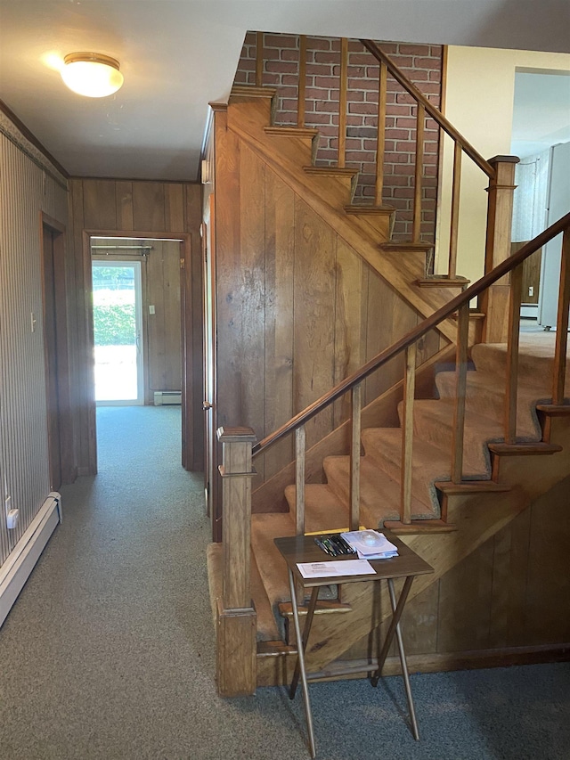 15 Vernon Ave, Rochester, NH 03867 - staircase with a baseboard heating unit, carpet, wood walls, and a baseboard radiator