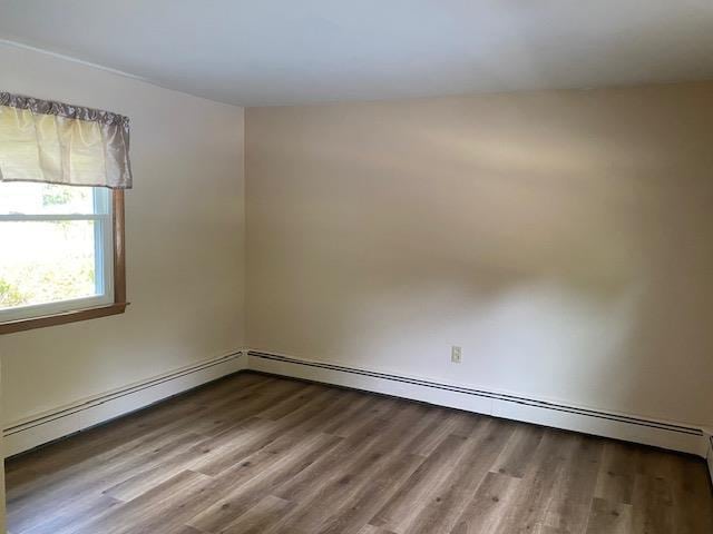 15 Vernon Ave, Rochester, NH 03867 - empty room featuring wood finished floors and a baseboard radiator