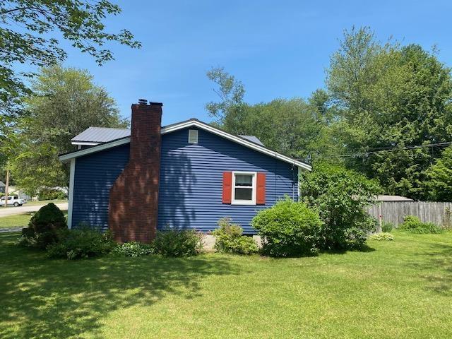 15 Vernon Ave, Rochester, NH 03867 - view of side of property featuring a chimney