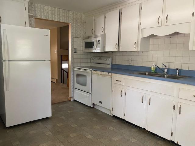 15 Vernon Ave, Rochester, NH 03867 - kitchen featuring white appliances, wallpapered walls, tasteful backsplash, and white cabinets