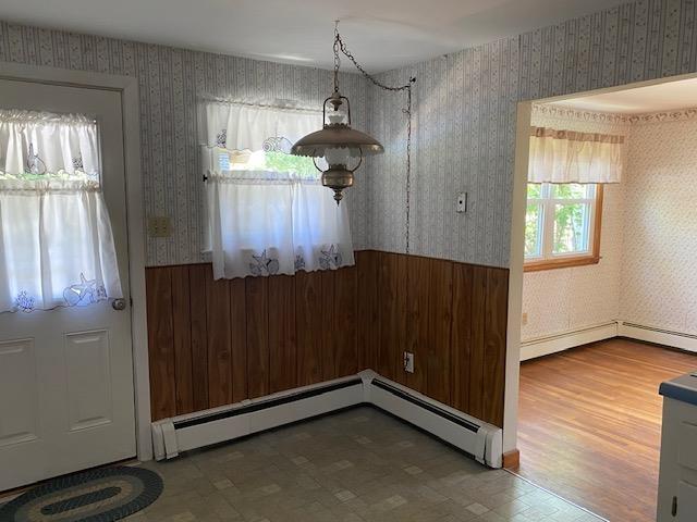 15 Vernon Ave, Rochester, NH 03867 - unfurnished dining area featuring wallpapered walls and a baseboard heating unit