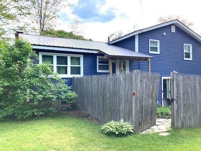 15 Vernon Ave, Rochester, NH 03867 - view of property exterior featuring a metal roof and a chimney