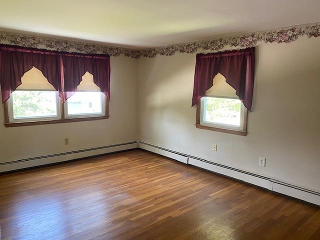 15 Vernon Ave, Rochester, NH 03867 - empty room featuring wood finished floors and baseboard heating