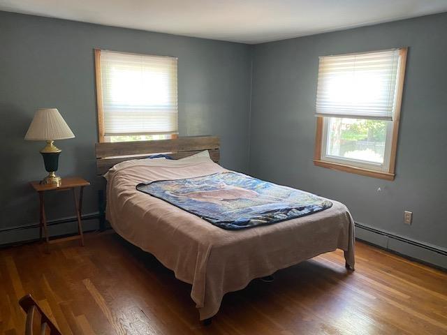 15 Vernon Ave, Rochester, NH 03867 - bedroom with wood finished floors and a baseboard heating unit