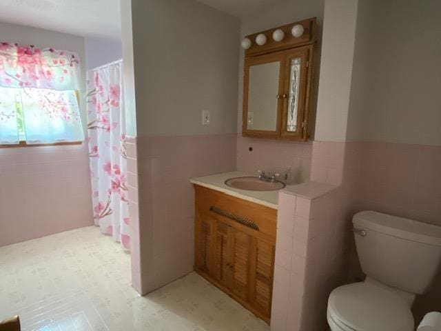 15 Vernon Ave, Rochester, NH 03867 - full bathroom featuring tile walls, vanity, wainscoting, tile patterned floors, and a shower with shower curtain