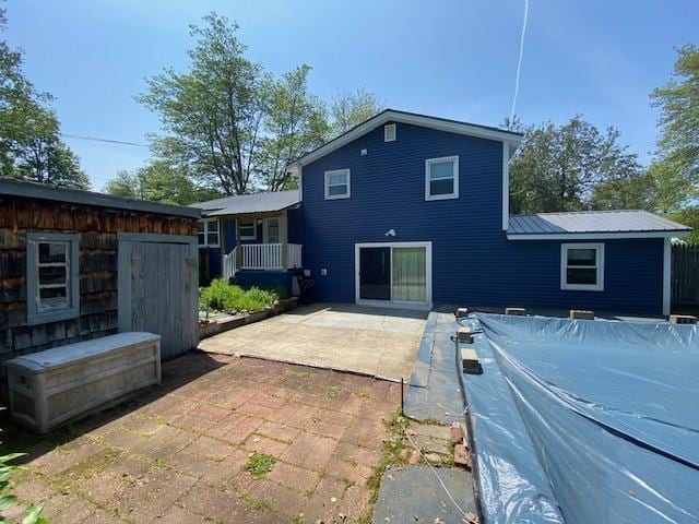 15 Vernon Ave, Rochester, NH 03867 - back of house with a patio area and a metal roof