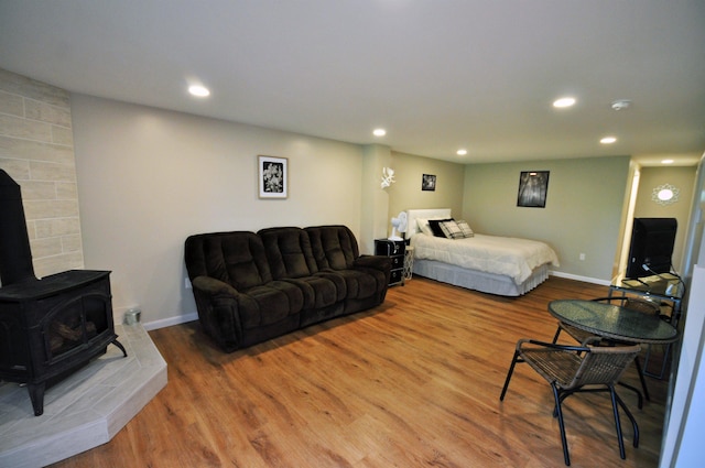17 Village W Dr Unit 11, Bristol, NH 03222 - bedroom with recessed lighting, wood finished floors, and a wood stove