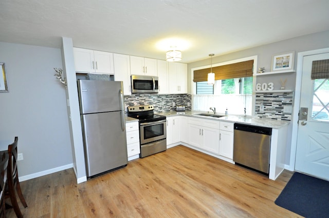17 Village W Dr Unit 11, Bristol, NH 03222 - kitchen featuring stainless steel appliances, backsplash, and white cabinetry