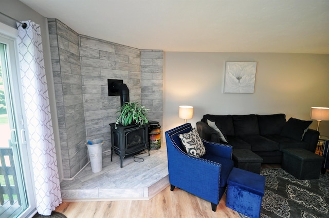 17 Village W Dr Unit 11, Bristol, NH 03222 - living room featuring a wood stove and wood finished floors