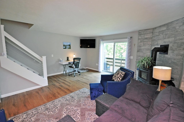 17 Village W Dr Unit 11, Bristol, NH 03222 - living area with a wood stove, stairway, wood finished floors, and an office area