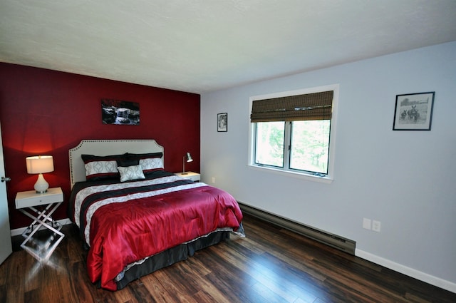 17 Village W Dr Unit 11, Bristol, NH 03222 - bedroom featuring a baseboard heating unit, an accent wall, and wood finished floors