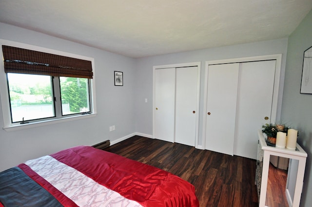 17 Village W Dr Unit 11, Bristol, NH 03222 - bedroom featuring dark wood-type flooring, two closets, and a baseboard heating unit
