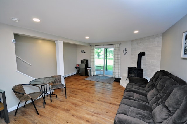 17 Village W Dr Unit 11, Bristol, NH 03222 - living area with a wood stove, a baseboard radiator, light wood finished floors, and recessed lighting
