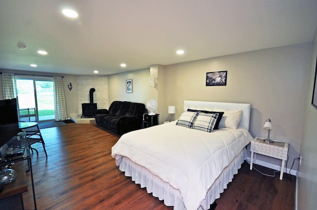 17 Village W Dr Unit 11, Bristol, NH 03222 - bedroom featuring a wood stove, recessed lighting, access to outside, and wood finished floors