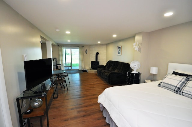 17 Village W Dr Unit 11, Bristol, NH 03222 - bedroom featuring a wood stove, recessed lighting, wood finished floors, and access to exterior