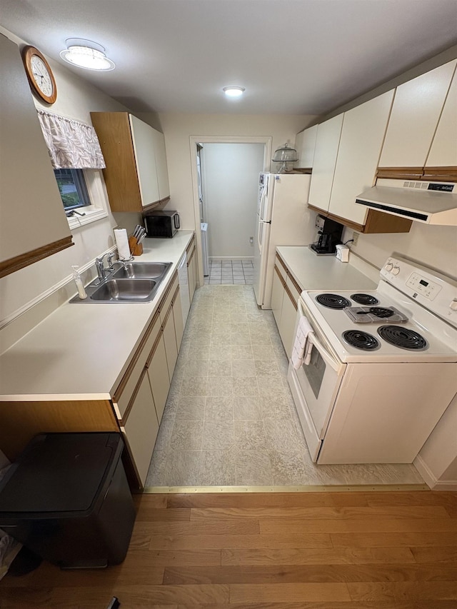 71 Esker Rd Unit B, Hampton, NH 03842 - kitchen featuring white appliances, under cabinet range hood, light countertops, light wood-type flooring, and white cabinetry
