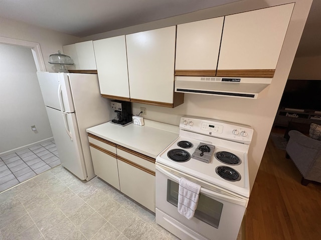 71 Esker Rd Unit B, Hampton, NH 03842 - kitchen with white appliances, under cabinet range hood, light countertops, and white cabinetry