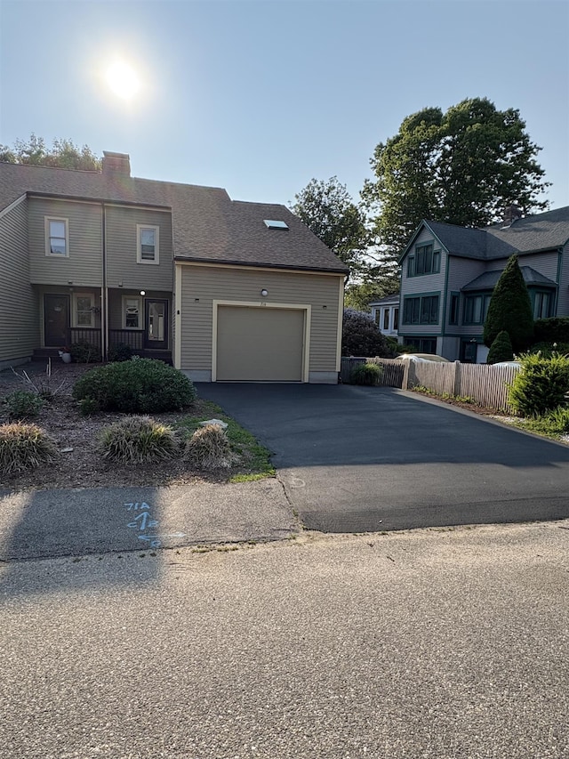 71 Esker Rd Unit B, Hampton, NH 03842 - view of front of property featuring driveway, a garage, and a chimney