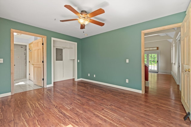 592 Old Bristol Rd, New Hampton, NH 03256 - unfurnished bedroom with wood finished floors, electric panel, ceiling fan, and connected bathroom