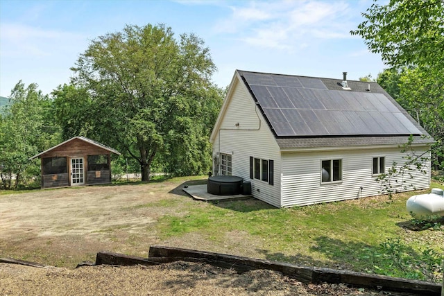 592 Old Bristol Rd, New Hampton, NH 03256 - rear view of property with solar panels and an outdoor structure