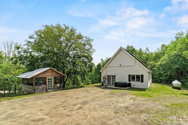 592 Old Bristol Rd, New Hampton, NH 03256 - back of property with exterior structure, an outbuilding, and view of wooded area