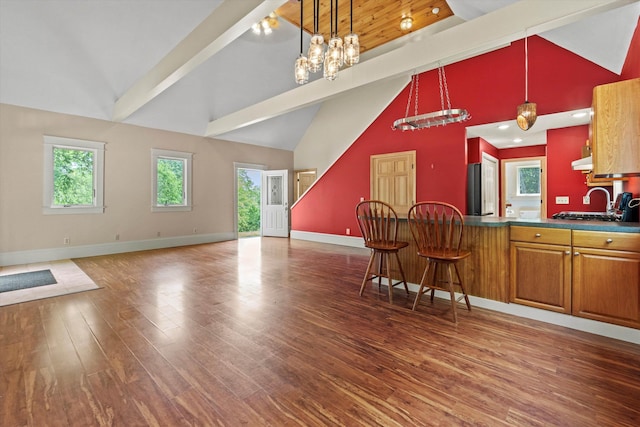 592 Old Bristol Rd, New Hampton, NH 03256 - kitchen with wood finished floors, open floor plan, pendant lighting, brown cabinetry, and a breakfast bar