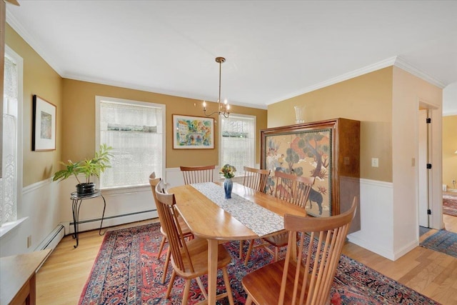 236 Lefebvre Ln, Williston, VT 05495 - dining area with light wood-style flooring, crown molding, and a chandelier