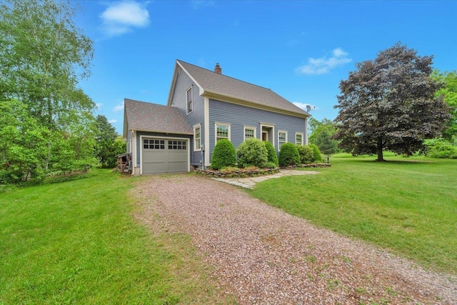 236 Lefebvre Ln, Williston, VT 05495 - view of side of home featuring driveway, a chimney, a garage, and a yard