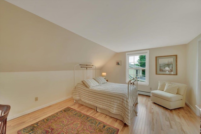 236 Lefebvre Ln, Williston, VT 05495 - bedroom featuring a baseboard radiator, light wood-type flooring, and lofted ceiling