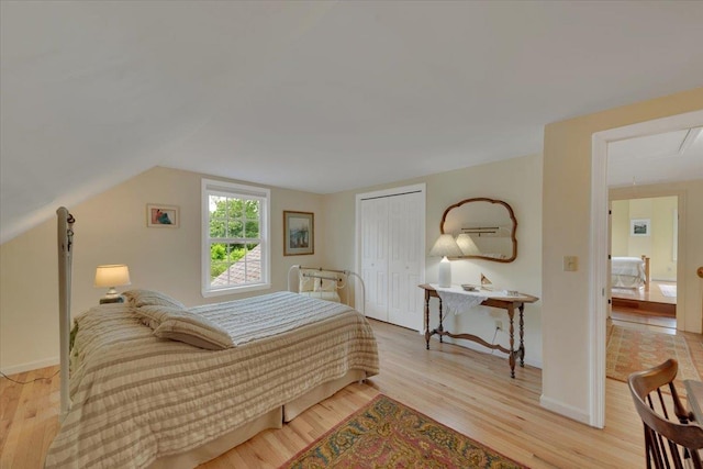 236 Lefebvre Ln, Williston, VT 05495 - bedroom with light wood-style flooring, attic access, a closet, and vaulted ceiling