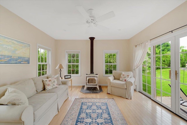 236 Lefebvre Ln, Williston, VT 05495 - living area featuring a wood stove, light wood-style floors, and a ceiling fan
