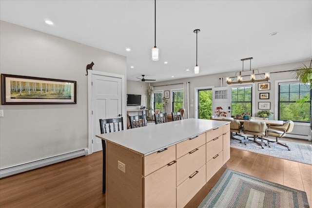 27 Hidden View Rd, Underhill, VT 05489 - kitchen featuring dark wood finished floors, a baseboard heating unit, a center island, healthy amount of natural light, and recessed lighting
