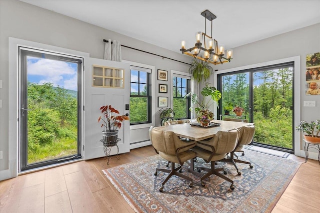 27 Hidden View Rd, Underhill, VT 05489 - dining area featuring a chandelier, a baseboard radiator, light wood-style flooring, and healthy amount of natural light