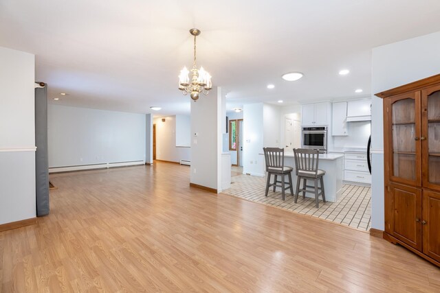 11 Penny Ln, Laconia, NH 03246 - kitchen featuring oven, a baseboard heating unit, light wood-type flooring, light countertops, and recessed lighting