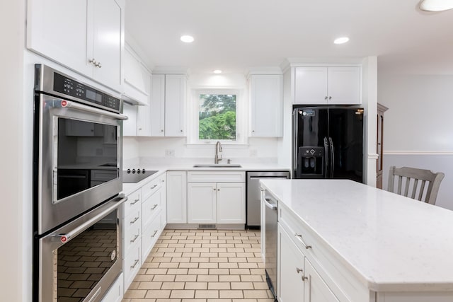 11 Penny Ln, Laconia, NH 03246 - kitchen featuring black appliances, a center island, white cabinetry, recessed lighting, and light stone counters