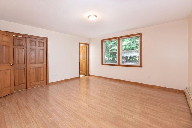 11 Penny Ln, Laconia, NH 03246 - unfurnished bedroom with light wood-type flooring, baseboard heating, and a closet